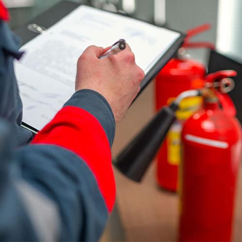 Fire Warden Inspecting Fire Extinguishers